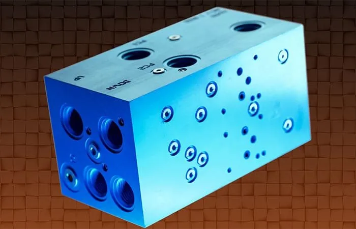 Blue anodized aluminum hydraulic manifold block shown in a product photo