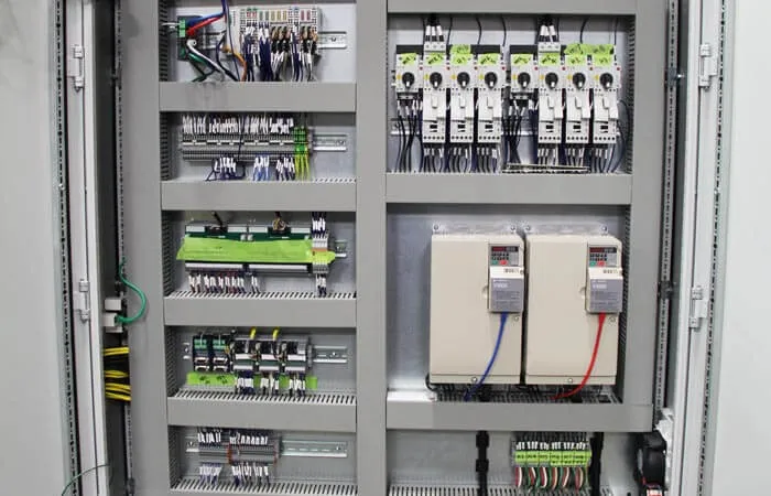 Open control panel with PLC modules, breakers and variable frequency drives