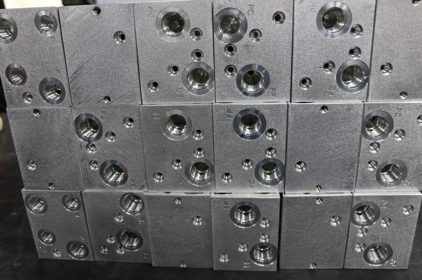 Stacked aluminum hydraulic manifold blocks with machined ports