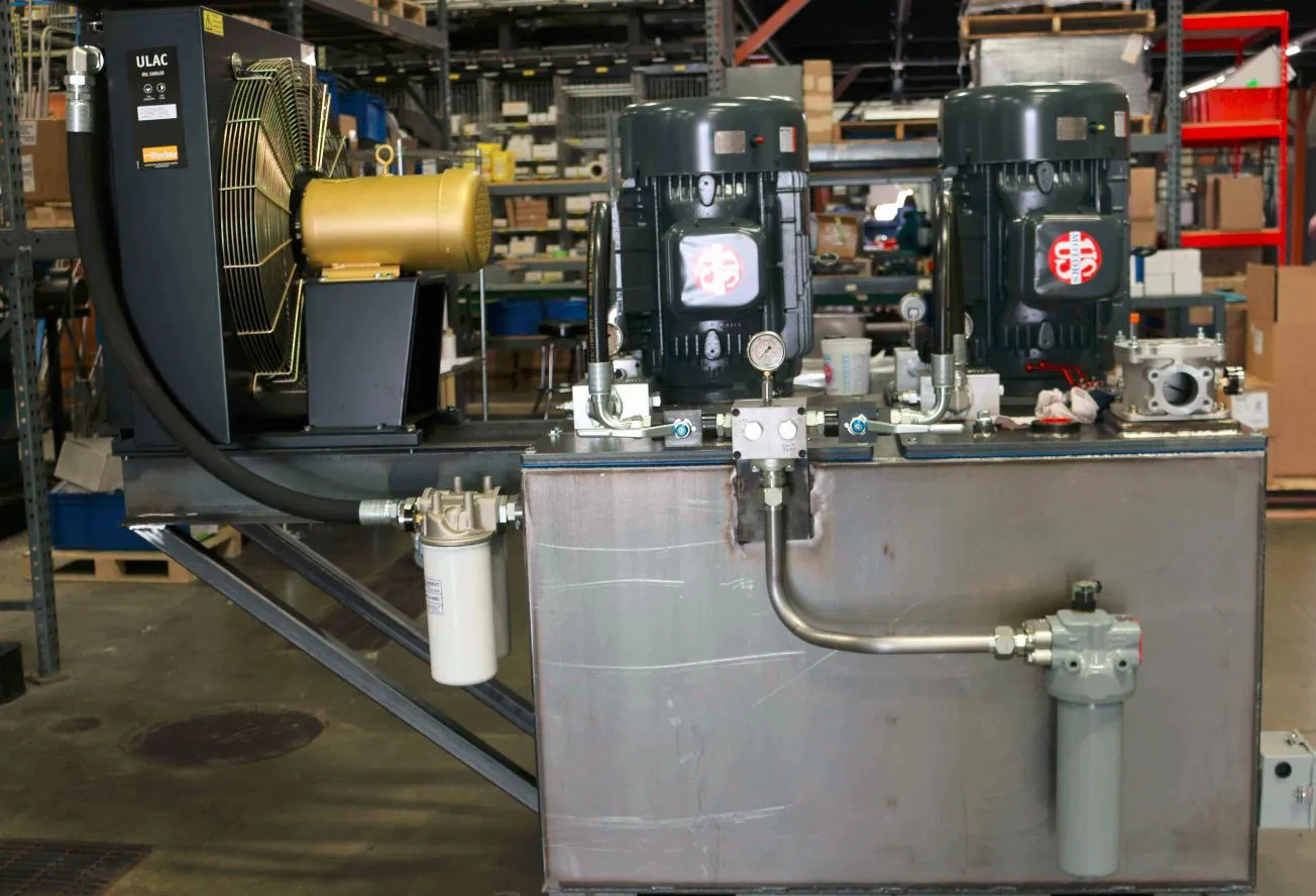 Hydraulic power unit with two US Motors-branded motors, a Parker ULAC oil cooler and gauges, in a warehouse