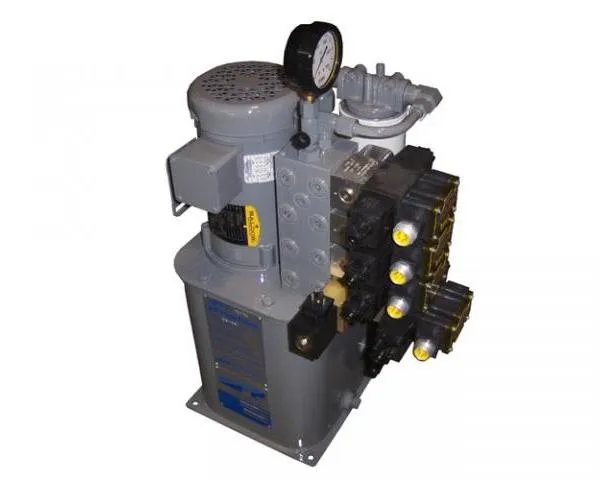 Gray hydraulic power unit with a valve manifold and pressure gauge, shown against a white background