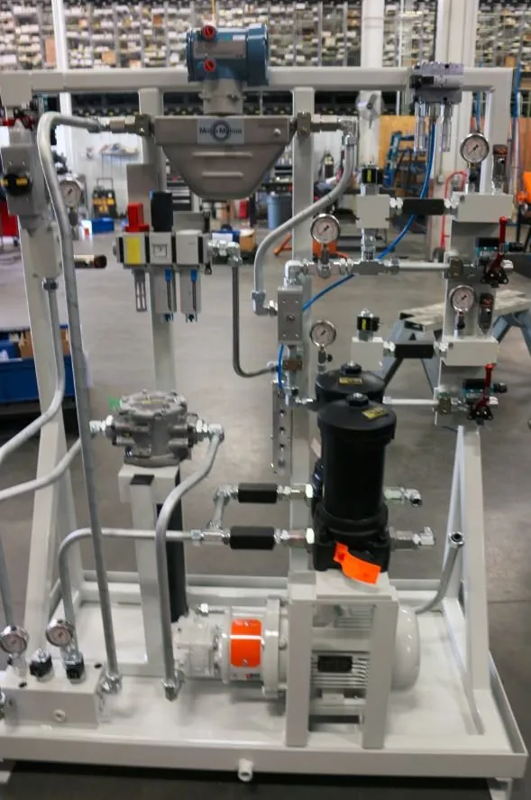 Hydraulic power unit skid on wheels with multiple pressure gauges, filters and valves in a warehouse aisle