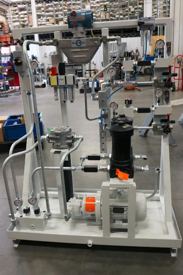 A hydraulic metering skid with a Micro-Motion flow meter and valve manifolds, viewed from the front