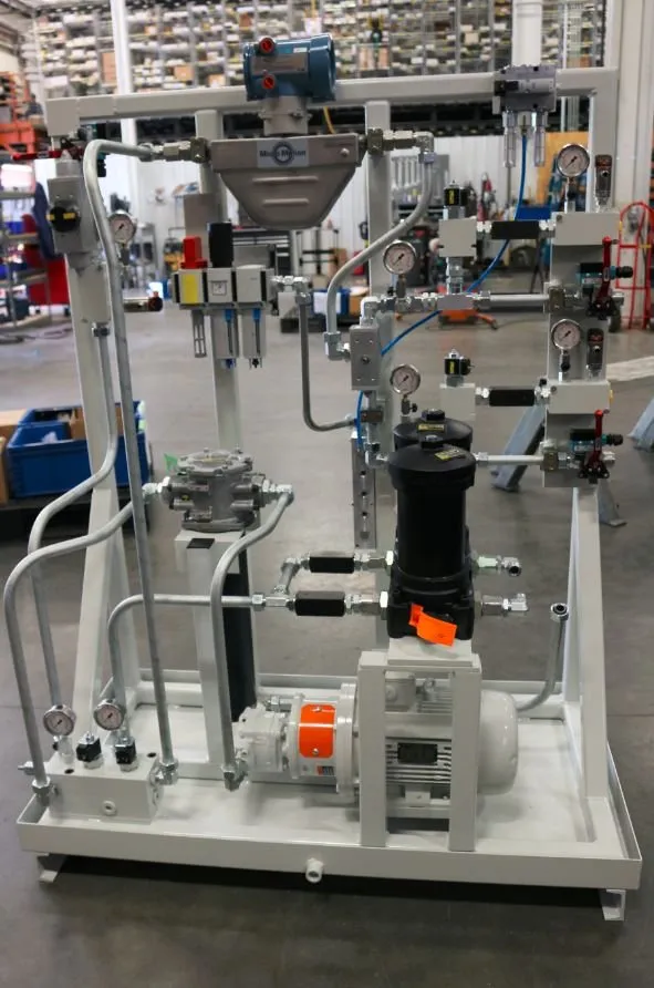 A hydraulic metering skid with a Micro-Motion flow meter, gauges, filters and valve manifolds on a steel frame