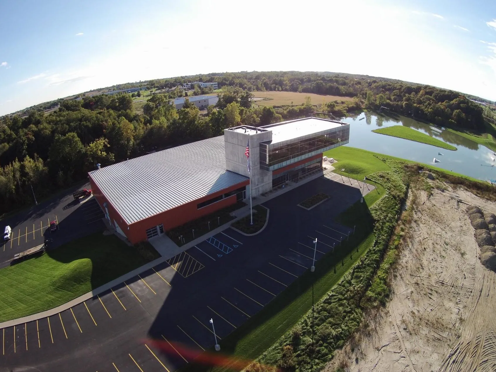Aerial view of MFP's Hudsonville, MI headquarters, its parking lot and the pond beside it