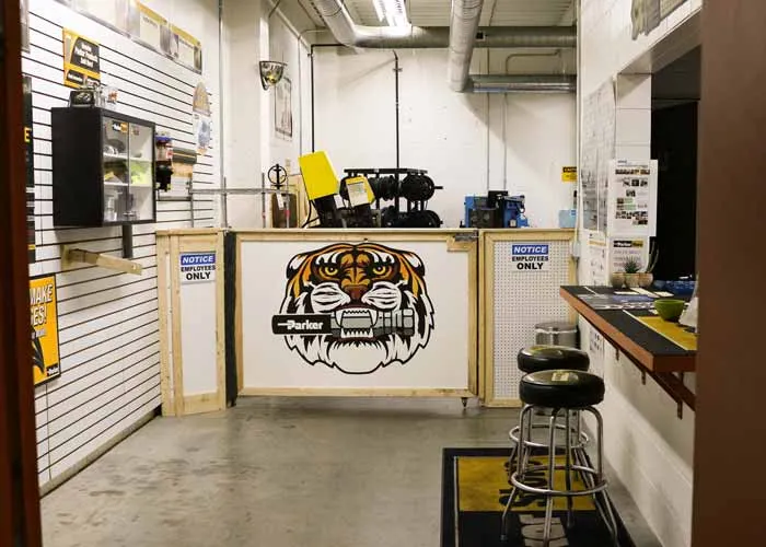 The ParkerStore counter at MFP Automation Engineering in Hudsonville, Michigan, with the Parker tiger mural behind it.