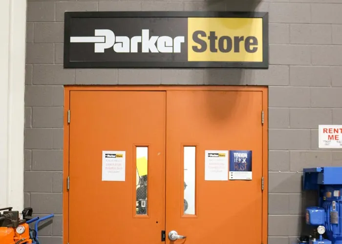 The ParkerStore entrance on the lower level of MFP Automation Engineering in Hudsonville, Michigan, with the ParkerStore sign above orange double doors.