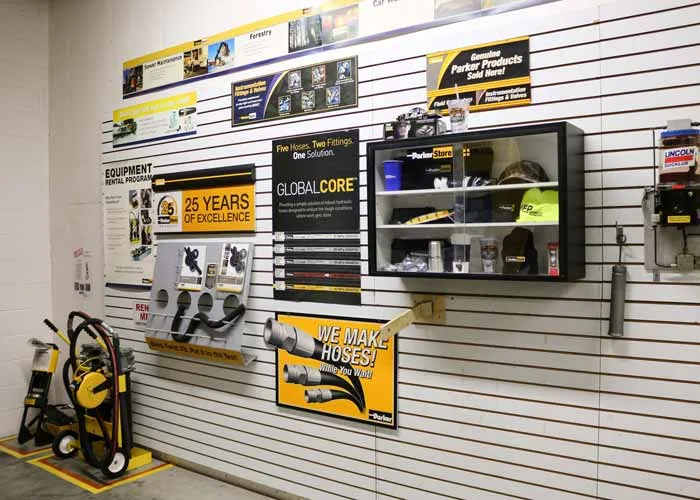 Parker hose assembly display wall at MFP's Hudsonville, Michigan ParkerStore, with GlobalCore hose samples and crimping equipment.