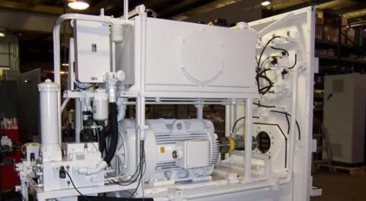 Large white hydraulic power unit cabinet with its access door open, showing the motor and piping inside