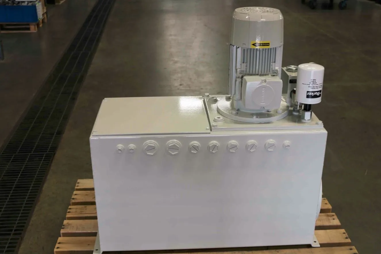 White hydraulic power unit with a Siemens motor and Parker filter on a wood pallet in a warehouse